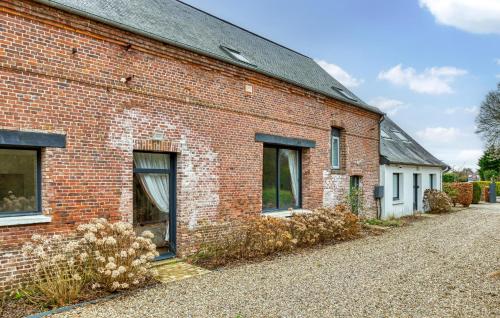 a red brick building with windows and a driveway at Gorgeous Home In Luneray With Wifi in Luneray