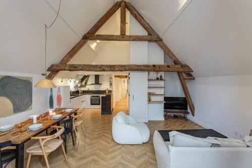 a living room with a table and a dining room at Appartement Mer et Pierres - Welkeys in Saint-Jean-de-Luz