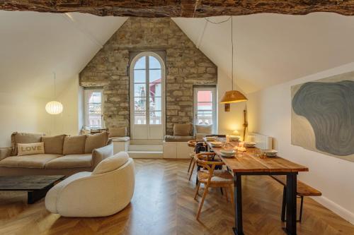 a living room with a table and a couch at Appartement Mer et Pierres - Welkeys in Saint-Jean-de-Luz