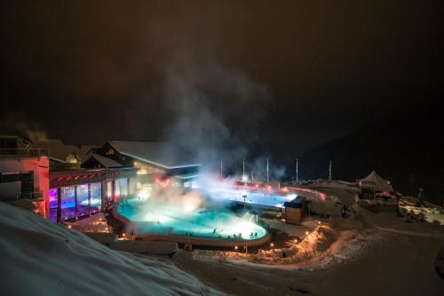 a group of lights in the snow at night at Hôtel Les Bains d'Ovronnaz in Ovronnaz
