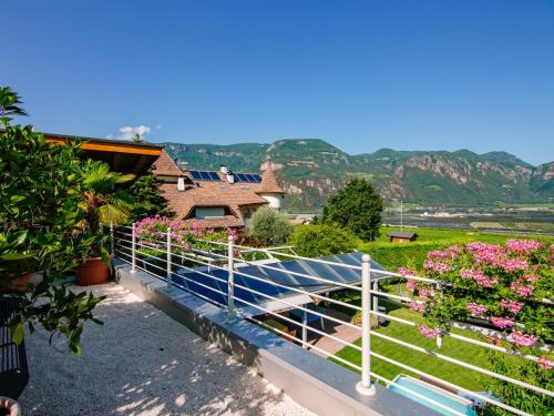 a white fence with flowers in a yard at Apartment Wolfsthurn by Interhome in Andrian
