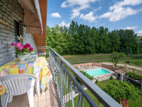 a balcony with a table and a swimming pool at Apartment Ca' D'Gnese by Interhome in Castagnole Lanze