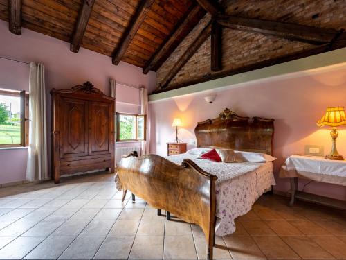 a bedroom with a large wooden bed in a room at Holiday Home Antica Cascina by Interhome in Castagnole Lanze