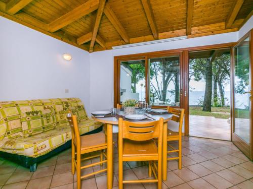 a dining room with a table and chairs and a couch at Holiday Home Villino Miramare by Interhome in Belvedere