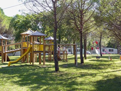 a playground with a yellow slide in a park at Holiday Home Villino Miramare by Interhome in Belvedere