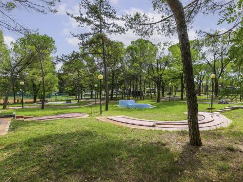 a park with a blue bench and trees at Holiday Home Villino Miramare by Interhome in Belvedere