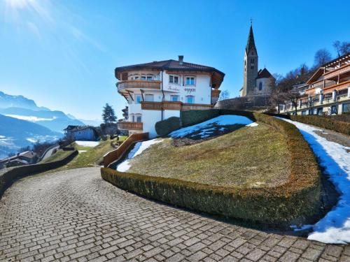a house on a hill with snow on the ground at Apartment Residence Egger - n-202 by Interhome in Villandro