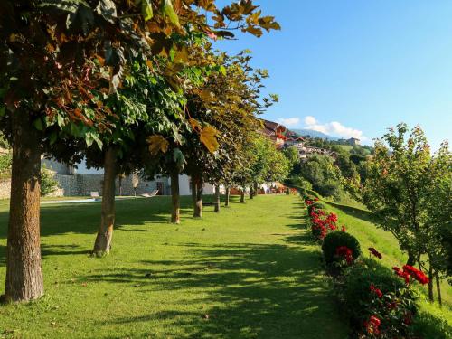 a row of trees and flowers in a park at Apartment Residence Egger - n-202 by Interhome in Villandro