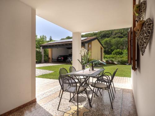 a dining room with a table and chairs on a patio at Holiday Home Villa Stelis by Interhome in Sequals