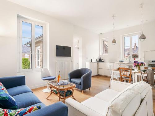 a living room with a couch and a table at Holiday Home La Floriette by Interhome in Dinard