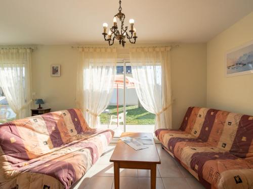 salon z dwiema kanapami i stołem w obiekcie Holiday Home Hortensias by Interhome w mieście Clohars-Carnoët