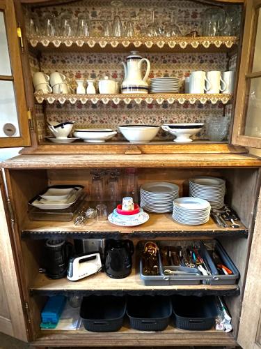 a cabinet filled with dishes and plates on top at Ickelhaus 2 in Bad Windsheim