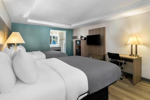 a hotel room with a large bed and a desk at Quality Inn Downtown Helen in Helen