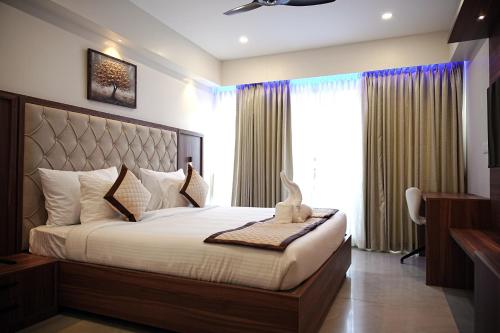 a bedroom with a large bed and a window at Tranquil Riverview Inn in Kottayam