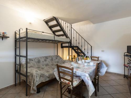 a dining room with a table and a bunk bed at Holiday Home Villetta Paola - IMP232 by Interhome in Caramagna Ligure