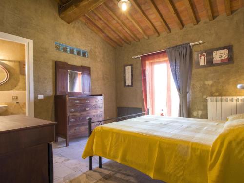 a bedroom with a bed and a dresser and a window at Holiday Home Celeste by Interhome in Castelvecchio