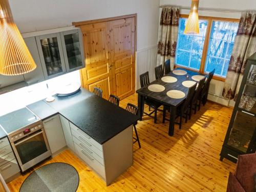 a kitchen and dining room with a table and chairs at Holiday Home Katinkulma 2 by Interhome in Vuokatti