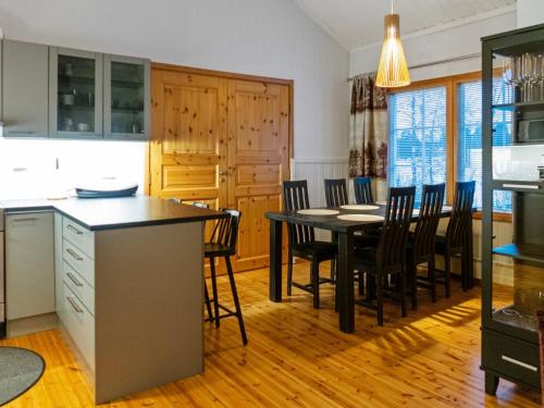 a kitchen and dining room with a table and chairs at Holiday Home Katinkulma 2 by Interhome in Vuokatti