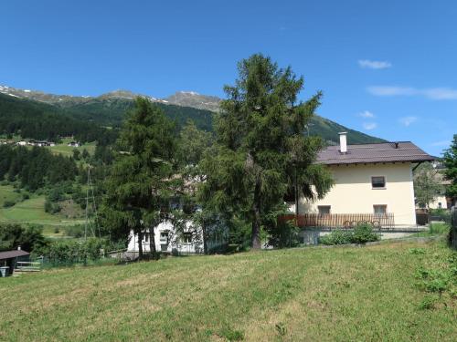 a house on a hill with mountains in the background at Apartment Nebenhaus Schönblick - SVH112 by Interhome in San Valentino alla Muta