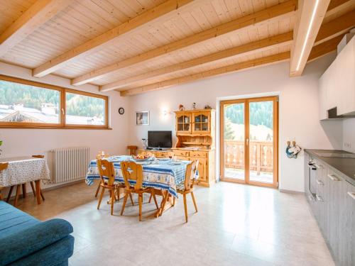 a kitchen and dining room with a table and chairs at Apartment Saslench by Interhome in Pera
