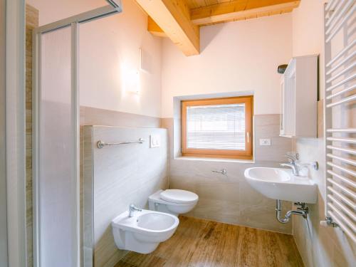 a bathroom with a toilet and a sink at Apartment Saslench by Interhome in Pera