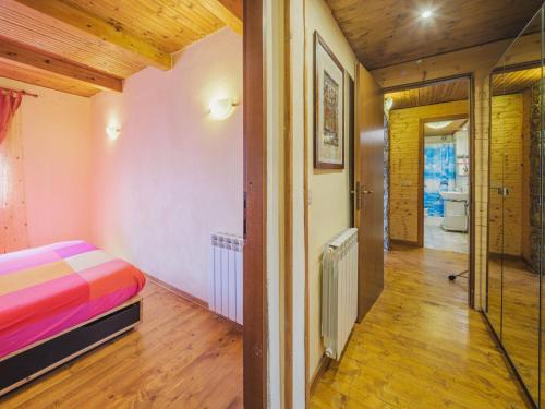 a bedroom with a bed and a hallway at Chalet Mare e Monti by Interhome in Antona
