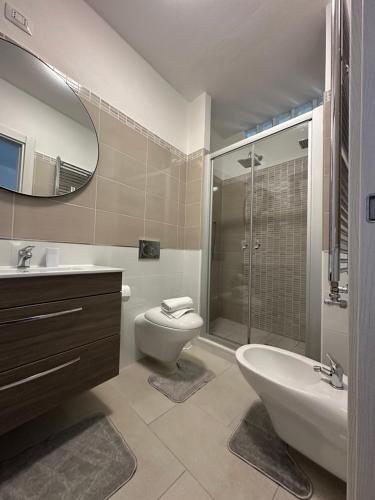 a bathroom with a sink toilet and a mirror at Beautiful Apartment with Swimming Pool in Olbia