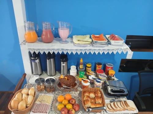 a table topped with lots of food and drinks at Pousada Milagres de Maria in Aparecida