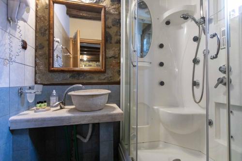 a bathroom with a sink and a shower at Suites Mouses in Palaios Agios Athanasios
