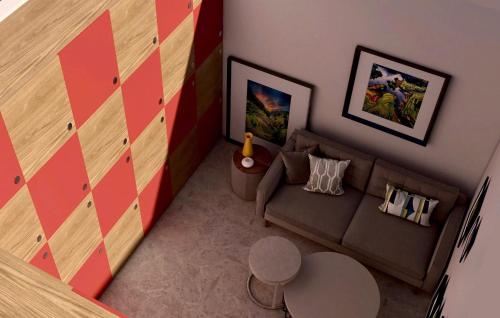 a living room with a couch and a wall at Hanoi Backpackers Lodge in Hanoi