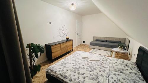 a bedroom with a bed and a couch at Evelin, Slovakia in Habovka