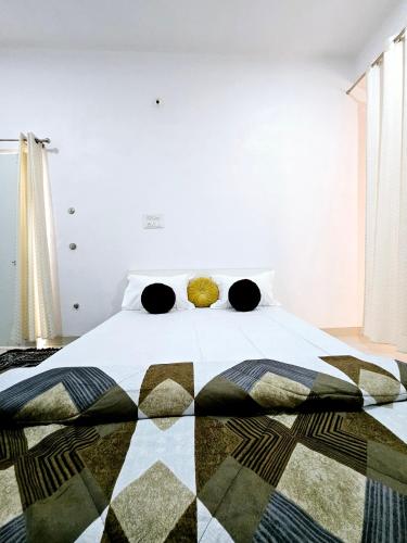 a bedroom with a large bed with a blanket on it at Nikunj Mahal Homestay in Udaipur
