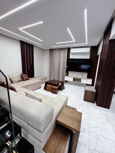 a large living room with a couch and a table at Luxury three bedroom duplexSheraton Airport in Cairo