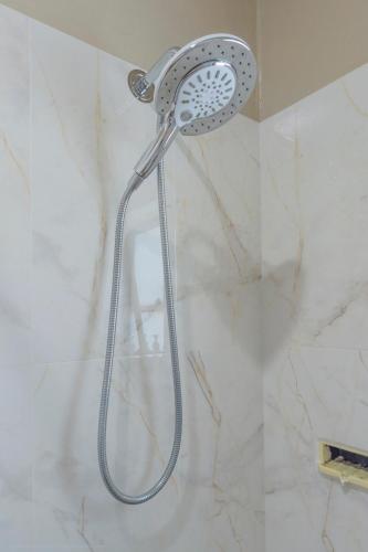 a shower with a shower head in a bathroom at U1 - Quaint 1 Bedroom Unit, Wanda Beach in Cronulla