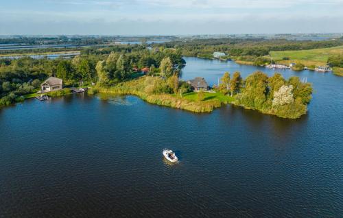 an island in the middle of a lake with a boat at 3 Bedroom Lovely Home In Warten in Warten