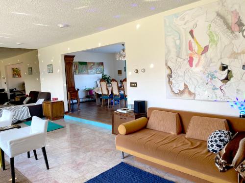 a living room with a couch and a dining room at Daydream Mountain Art Chateau in Catskill