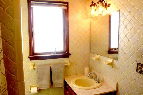 a bathroom with a sink and a window and a mirror at Daydream Mountain Art Chateau in Catskill