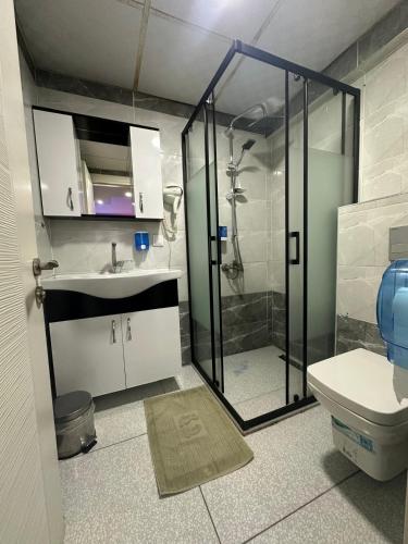 a bathroom with a shower and a sink and a toilet at Vero Hotel in Konak