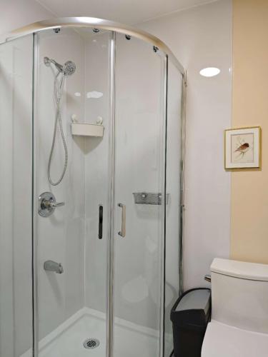 a shower with a glass door in a bathroom at sweet home in Richmond