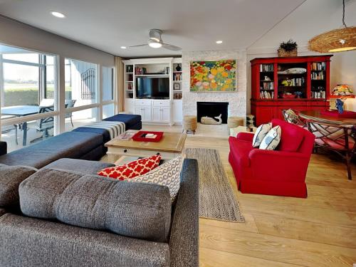 a living room with a couch and a red chair at Ponte Vedra Deer Run 9770 in Ponte Vedra
