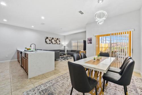 a kitchen and living room with a table and chairs at Lakefront 4 Bed private Oasis Location in Kissimmee