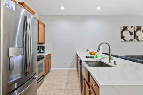 a kitchen with a stainless steel refrigerator at Lakefront 4 Bed private Oasis Location in Kissimmee