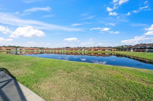 a body of water with houses in the background at Lakefront 4 Bed private Oasis Location in Kissimmee