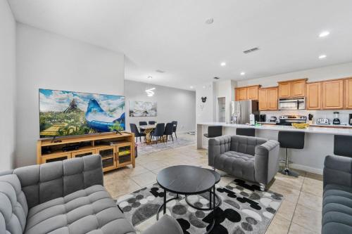a living room with two couches and a kitchen at Lakefront 4 Bed private Oasis Location in Kissimmee