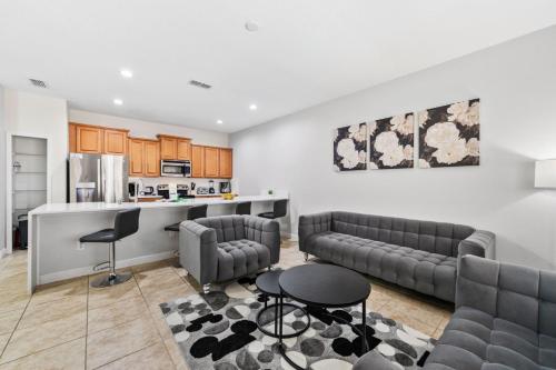 a living room with couches and a kitchen at Lakefront 4 Bed private Oasis Location in Kissimmee