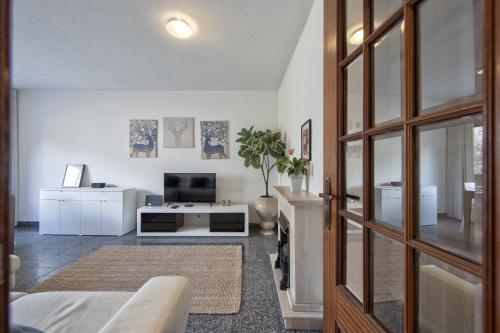 a living room with a tv and a couch at Pontinha Typical by Homing in Lisbon