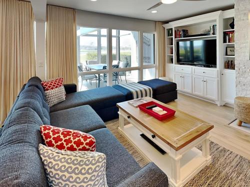 a living room with a blue couch and a tv at Ponte Vedra Deer Run 9770 in Ponte Vedra