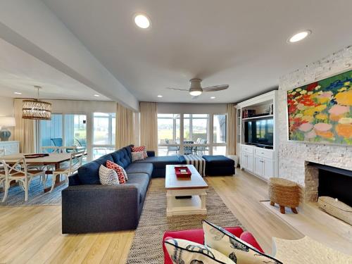 a living room with a blue couch and a fireplace at Ponte Vedra Deer Run 9770 in Ponte Vedra
