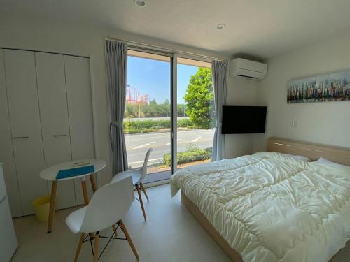a bedroom with a bed and a table and a window at THE LAND HOTEL - Vacation STAY 16085v in Arao