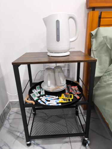a table with a coffee maker on top of it at Edlin Guest House in Reading
